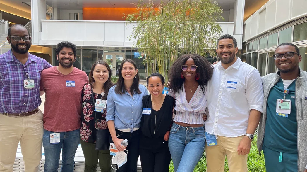 A group of residents, fellows, and mentors in the courtyard of Geffen Hall at UCLA