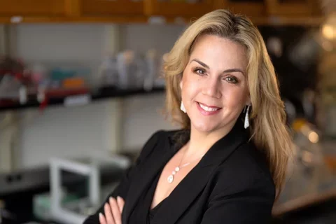 woman with long blonde hair and black top