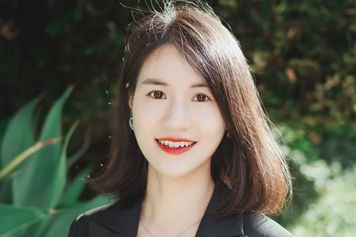 woman with short black hair and black top