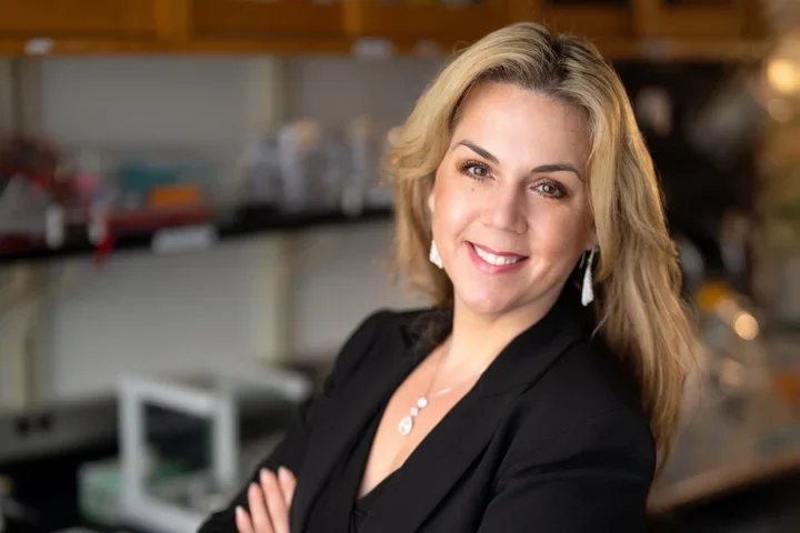 woman with long blonde hair and black top