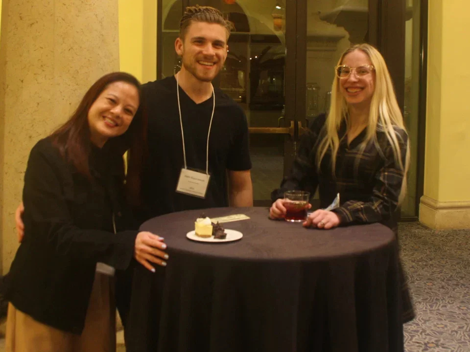 three students smiling at camera