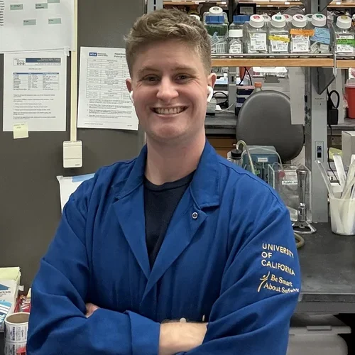 graduate student wearing blue lab coat 