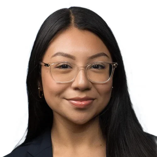 female with dark hair wearing a dark blazer smiling at camera