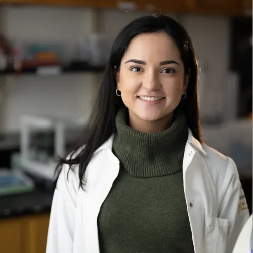 female in green shirt and white lab coat