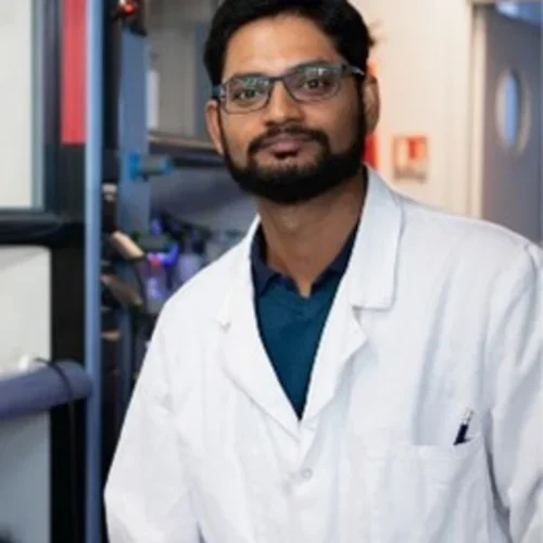 man wearing glasses in white lab coat