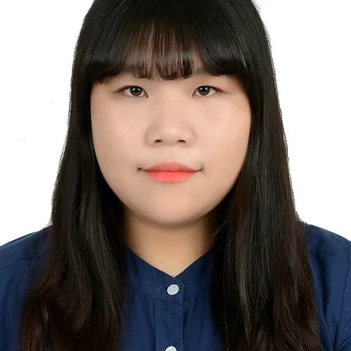 woman with long dark hair and a navy blue button-up shirt