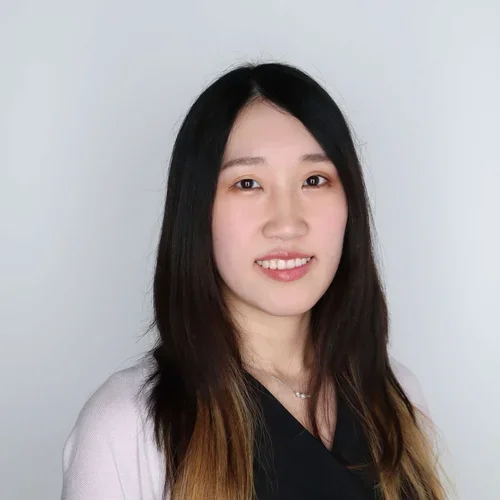 woman with black hair and dark top with white sweater