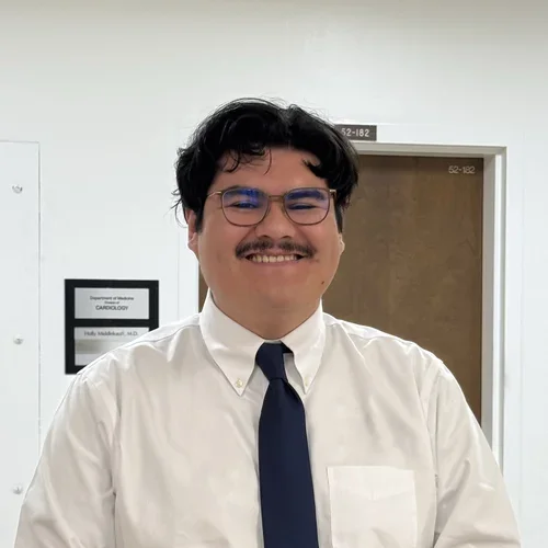 male in white shirt and black tie