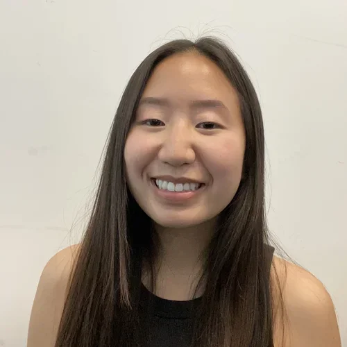 female with dark hair smiling at camera