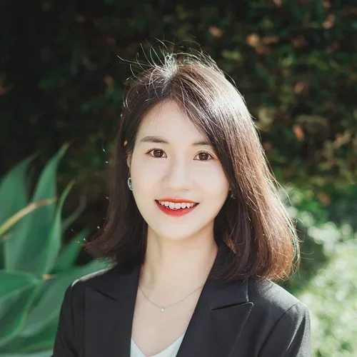 woman with short black hair and black top