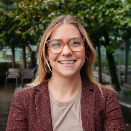 Woman with blonde/brown hair wearing glasses