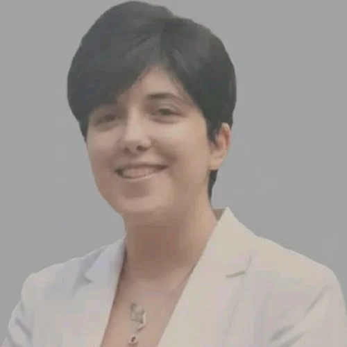 female with short, dark hair wearing white blazer
