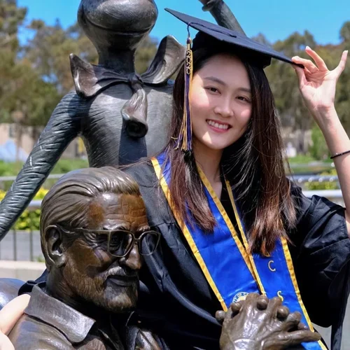 woman in black graduation cap and gown with blue and yellow UCSD stole