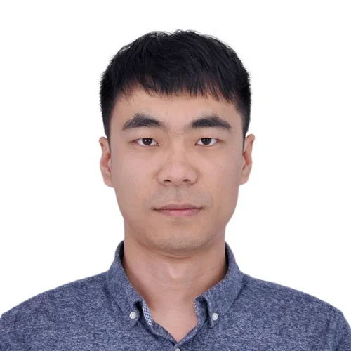 man with short black hair and dark collared shirt