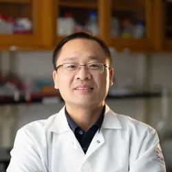 man with glasses wearing lab coat