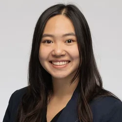 female with dark hair wearing navy blue blazer