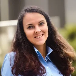 Woman with long dark hair and blue shirt