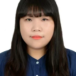 woman with long dark hair and a navy blue button-up shirt