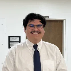 male in white shirt and black tie