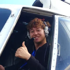 Man in helicopter sticking his thumb out