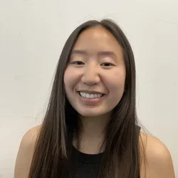 female with dark hair smiling at camera