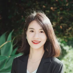 woman with short black hair and black top