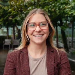 Woman with blonde/brown hair wearing glasses