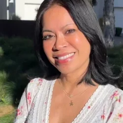 woman with short black hair and white blouse