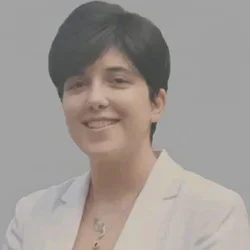 female with short, dark hair wearing white blazer