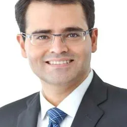 man with glasses and black suit jacket