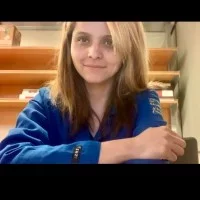 female in blue lab coat