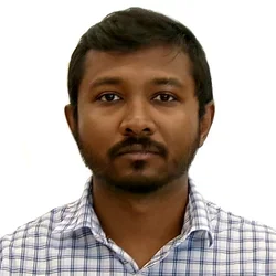 man with black hair and button up shirt