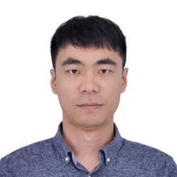 man with short black hair and dark collared shirt