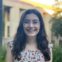 girl with dark hair wearing glasses 