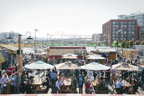 Overhead photo of people socializing umbrellas at a party