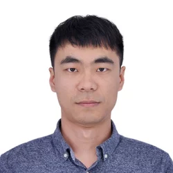 man with short black hair and dark collared shirt